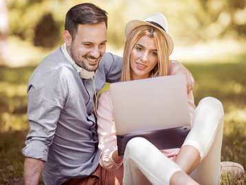 menschen-gemischt-paar-laptop-wiese